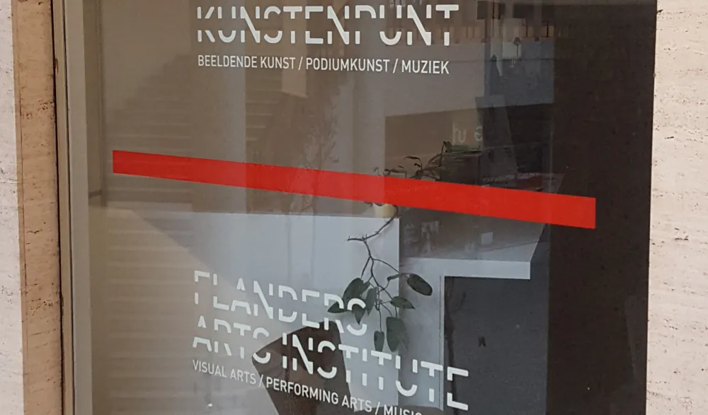 An office window displaying the text "Kunstenpunt // Flanders Art Institute"