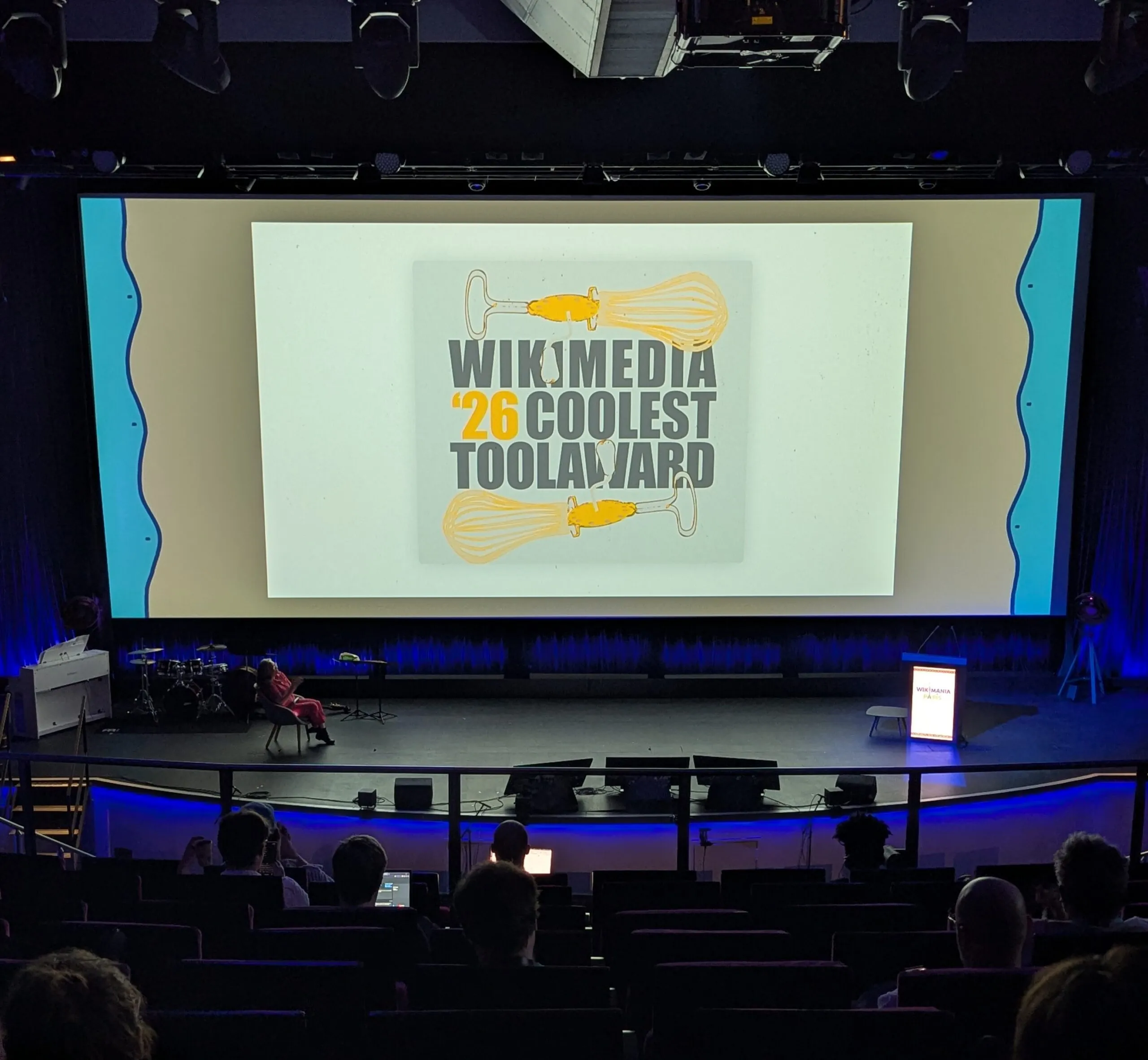 The Coolest Tool Awards presentation banner on the stage at Wikimania 2026.