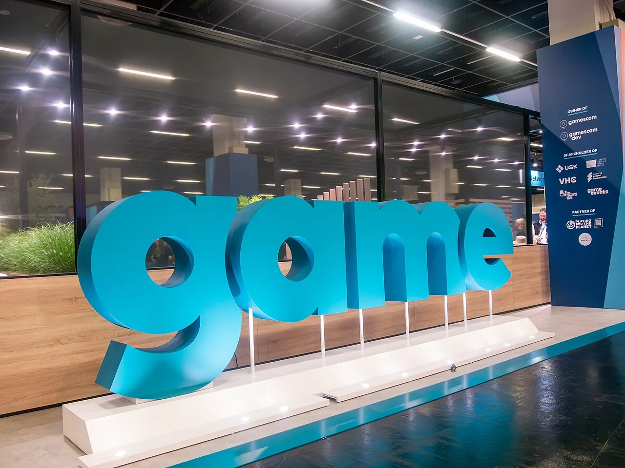 A large blue sculpture of the lower case word "game", as seen at the gamescom 2026 conference.
